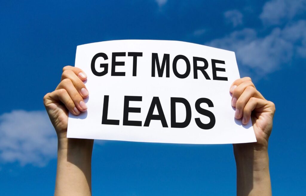 shows someone holding a sign saying 'GET MORE LEADS'