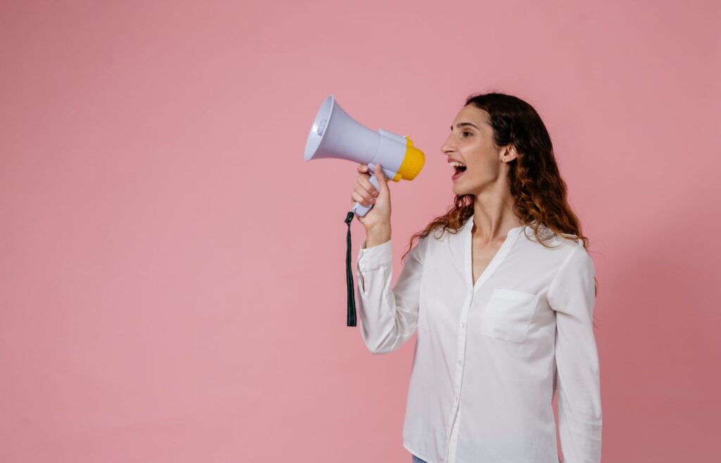 shows a woman shotuing down a megaphone