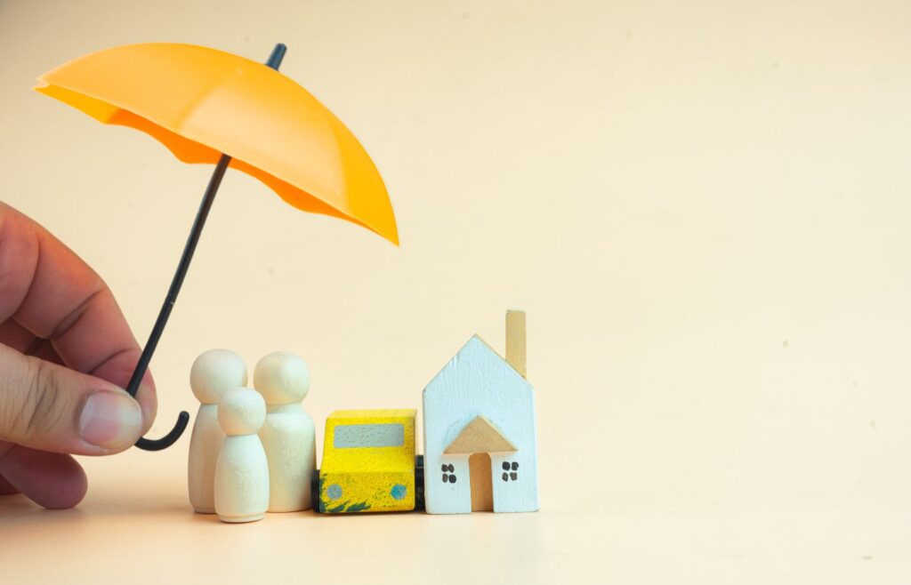 shows a man holding an orange umbrella next to a family made of playdough