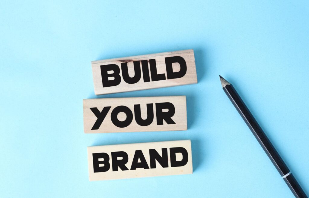 says the words BUILD YOUR BRAND on a blue background 