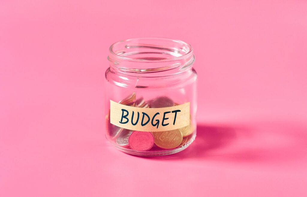 shows a money jar on a pink background