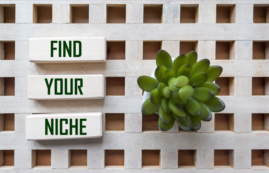 a wooden pallet and plant with the words FIND YOUR NICHE 