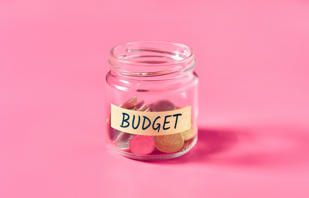 shows a glass coin jar in front of a pink background - 50 B2B blog topic ideas 