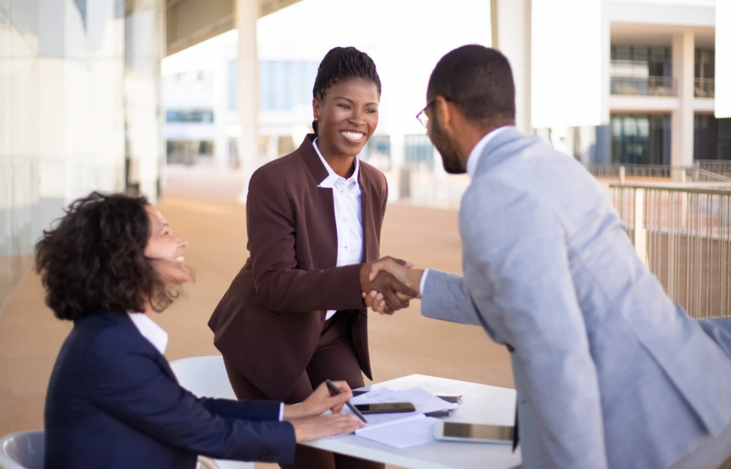 shows workers shaking hands - 50 B2b blog topic ideas 