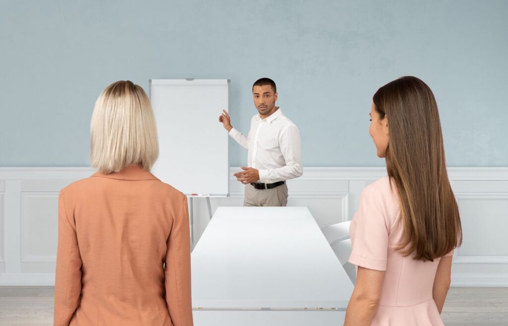 shows a man teaching on a white board 