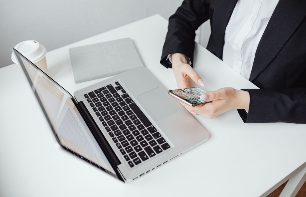 shows a woman on her phone on a white desk 